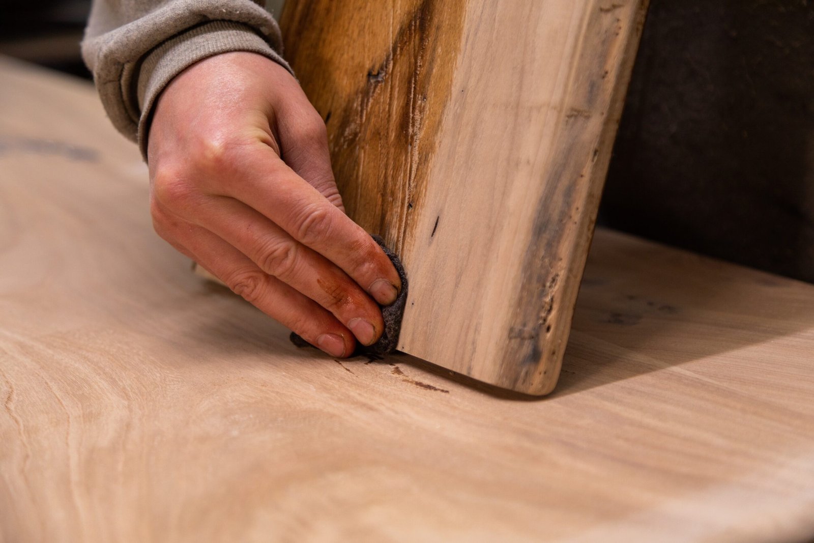 Closeup,Of,Carpenter,Coating,A,Wooden,Cutting,Board,With,Protective